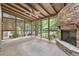 Sunroom featuring stone fireplace and ceiling fan with walls of windows and wooded view at 3200 Turtle Lake Se Ct, Marietta, GA 30067
