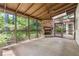 Cozy sunroom featuring stone fireplace, ceiling fan, and surrounded by natural views at 3200 Turtle Lake Se Ct, Marietta, GA 30067