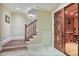 Basement staircase and a wine cellar with wooden racks and an ornate door at 3370 Habersham Nw Rd, Atlanta, GA 30305