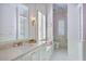 Pretty pink bathroom with marble countertops, built-in shelves, and a window at 3370 Habersham Nw Rd, Atlanta, GA 30305