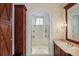Bathroom featuring a walk-in shower with gold hardware and a wooden vanity at 3370 Habersham Nw Rd, Atlanta, GA 30305