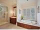 Bright bathroom featuring a soaking tub, walk-in shower, and wooden vanity at 3370 Habersham Nw Rd, Atlanta, GA 30305