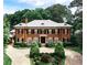 Elegant red brick home with manicured landscaping and a circular driveway at 3370 Habersham Nw Rd, Atlanta, GA 30305