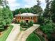 Impressive brick home with manicured landscaping and a circular driveway leading to a grand entrance and lush green surroundings at 3370 Habersham Nw Rd, Atlanta, GA 30305