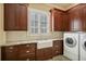 Laundry room with a farmhouse sink, granite countertops, and modern washer and dryer at 3370 Habersham Nw Rd, Atlanta, GA 30305