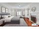 This light and airy main bedroom features a sitting area, fireplace, and hardwood floors at 3370 Habersham Nw Rd, Atlanta, GA 30305