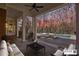 A covered outdoor patio with a pool and lounge chairs at twilight at 3370 Habersham Nw Rd, Atlanta, GA 30305