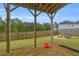 Lush backyard with a covered patio, fire pit, and plenty of space for recreation at 3510 Meadow Grass Dr, Dacula, GA 30019