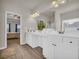 Well-lit bathroom with dual sinks, white cabinetry, and modern fixtures at 3510 Meadow Grass Dr, Dacula, GA 30019