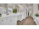 The primary bathroom features double sinks, a vanity area, lots of light, and wood-style floors at 3510 Meadow Grass Dr, Dacula, GA 30019