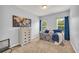 Cozy bedroom with light gray walls, a map decoration, and a day bed flanked by windows at 3510 Meadow Grass Dr, Dacula, GA 30019