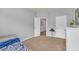 Neutral bedroom with carpet and doorways showing a small table and view of the flooring of another room at 3510 Meadow Grass Dr, Dacula, GA 30019