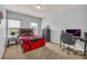 Comfortable bedroom with natural light from two windows, desk, bed, and neutral color palette at 3510 Meadow Grass Dr, Dacula, GA 30019