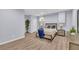 Bedroom features hard surface flooring, a bed with blue blanket, and nightstands with lamps at 3510 Meadow Grass Dr, Dacula, GA 30019