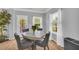 Cozy dining area with a modern table and chairs, natural light, and neutral paint at 3510 Meadow Grass Dr, Dacula, GA 30019
