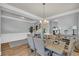 Bright dining area featuring hardwood floors, neutral paint, large table, and modern chandelier at 3510 Meadow Grass Dr, Dacula, GA 30019