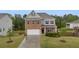 Charming two-story home featuring a brick facade and well-manicured front yard at 3510 Meadow Grass Dr, Dacula, GA 30019