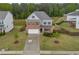 Two-story home featuring brick and cement board siding, a well-maintained lawn, and a two-car garage at 3510 Meadow Grass Dr, Dacula, GA 30019
