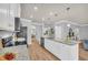 Open kitchen featuring an island with bar seating, granite countertops and stainless steel appliances at 3510 Meadow Grass Dr, Dacula, GA 30019