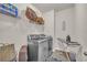 Well-organized laundry room featuring modern washer and dryer, shelving, and ironing station at 3510 Meadow Grass Dr, Dacula, GA 30019