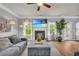 Comfortable living room features a fireplace, large TV, and an abundance of natural light at 3510 Meadow Grass Dr, Dacula, GA 30019