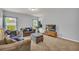 Cozy living room with a comfortable couch, ottoman, and a flatscreen TV at 3510 Meadow Grass Dr, Dacula, GA 30019