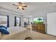 A spacious main bedroom boasts a ceiling fan, large windows, and an adjoining sitting area at 3510 Meadow Grass Dr, Dacula, GA 30019