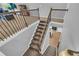 Carpeted staircase with a rod iron banister and an open view to the floor below at 3510 Meadow Grass Dr, Dacula, GA 30019