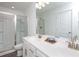 Bright bathroom with double vanity, sleek faucets, and a glass-enclosed shower for a modern feel at 5106 Arista Dr, Douglasville, GA 30135