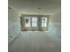 Spacious bedroom featuring three large windows, unfinished floors, and drywall walls at 5106 Arista Dr, Douglasville, GA 30135