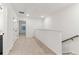 Bright hallway with carpeted floors, white walls, and a view of a window in the adjacent room at 5106 Arista Dr, Douglasville, GA 30135