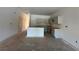 Spacious open kitchen area with an island and light gray cabinets awaiting countertops and appliances at 5106 Arista Dr, Douglasville, GA 30135