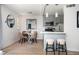 Dining area adjacent to a gray-cabinet kitchen with stainless steel appliances and a breakfast bar at 120 Alden Nw Ave # D2, Atlanta, GA 30309