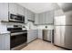 Updated kitchen features stainless steel appliances, grey cabinets, and tile backsplash at 120 Alden Nw Ave # D2, Atlanta, GA 30309
