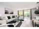 Bright and airy living room with a balcony, a bar, modern furnishings, and neutral colors, creating a cozy space at 120 Alden Nw Ave # D2, Atlanta, GA 30309