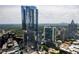 Stunning aerial view showcasing the modern high-rise building with city skyline and lush green landscape at 3344 Peachtree Ne Rd # 3601, Atlanta, GA 30326