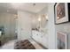 Bright bathroom featuring a glass shower, double vanity, and stylish chandelier lighting at 3344 Peachtree Ne Rd # 3601, Atlanta, GA 30326