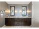 Modern bathroom with a double vanity, dark wood cabinets, and unique sconce lighting at 3344 Peachtree Ne Rd # 3601, Atlanta, GA 30326