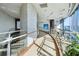 Bright hallway featuring curved architecture and a textured stone accent wall and glass railing at 3344 Peachtree Ne Rd # 3601, Atlanta, GA 30326