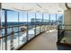 Hallway with glass railing overlooking outdoor lounge, offering great views and a modern aesthetic at 3344 Peachtree Ne Rd # 3601, Atlanta, GA 30326