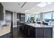 Modern kitchen featuring dark cabinetry, stone countertops, and open views of the surrounding landscape at 3344 Peachtree Ne Rd # 3601, Atlanta, GA 30326
