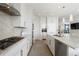 Modern kitchen with gas range, marble countertops, and stylish backsplash, featuring an open layout and ample storage at 3344 Peachtree Ne Rd # 3601, Atlanta, GA 30326