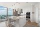Contemporary kitchen with a center island, built-in appliances, ample storage, and city skyline backdrop at 3344 Peachtree Ne Rd # 3601, Atlanta, GA 30326