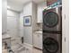 Well-organized laundry area with modern stacked washer/dryer, sink, and storage cabinets at 3344 Peachtree Ne Rd # 3601, Atlanta, GA 30326