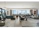 Open-concept living room featuring expansive windows, hardwood floors, and comfortable contemporary furnishings at 3344 Peachtree Ne Rd # 3601, Atlanta, GA 30326