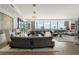 Spacious living room with hardwood floors, stylish furniture, and floor-to-ceiling windows with city views at 3344 Peachtree Ne Rd # 3601, Atlanta, GA 30326