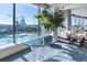 Bright living room featuring a large window with stunning city views, a swimming pool, and stylish decor at 3344 Peachtree Ne Rd # 3601, Atlanta, GA 30326