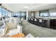 This living room boasts floor to ceiling windows, dining area, a grand piano, and a kitchen bar at 3344 Peachtree Ne Rd # 3601, Atlanta, GA 30326