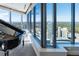 Living room with floor-to-ceiling windows offering expansive city views, complete with a grand piano at 3344 Peachtree Ne Rd # 3601, Atlanta, GA 30326