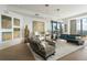 Elegant living room with curated art, hardwood flooring, and city skyline views from large windows at 3344 Peachtree Ne Rd # 3601, Atlanta, GA 30326